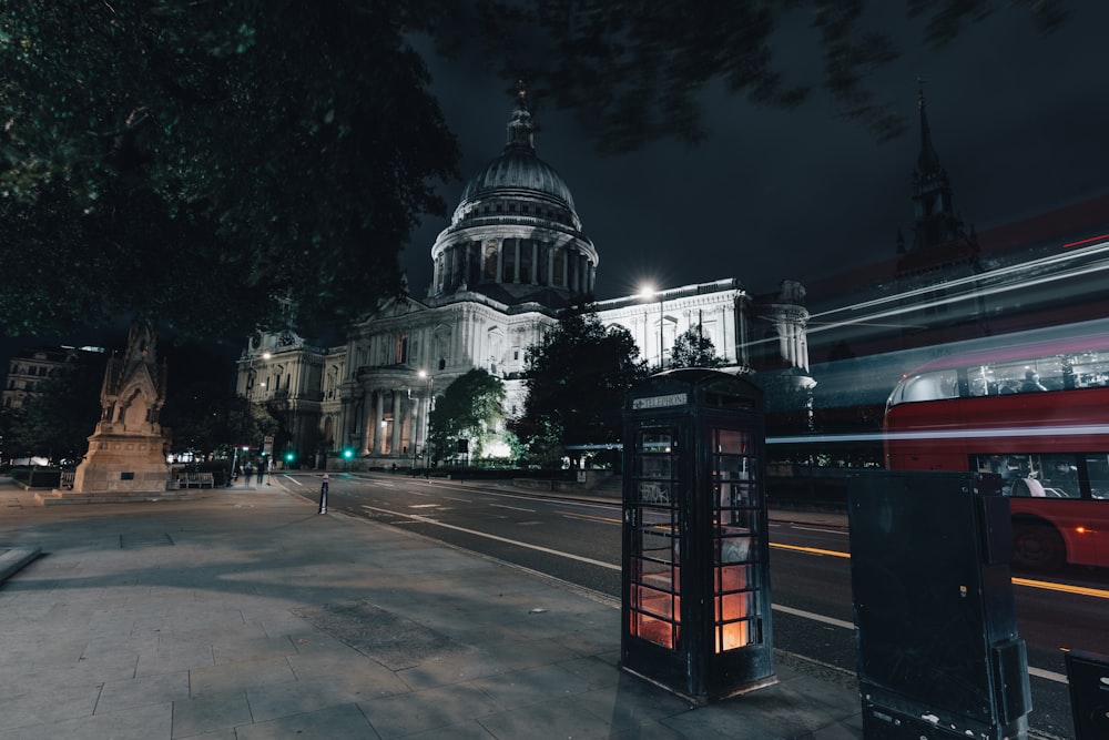 a city street at night with a building in the background