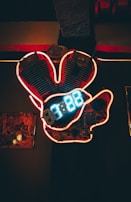 Nighttime city street with a glowing purple neon sign reading 'Ignition Lab' above a charcoal-colored sports car.