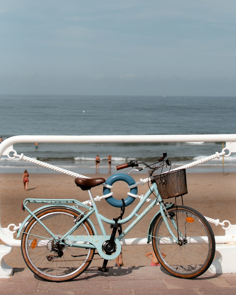 a blue bicycle parked on the side of a beach