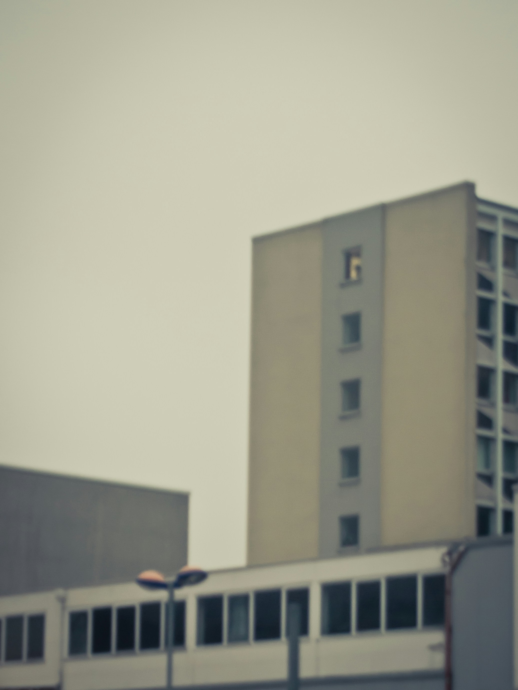 a tall building sitting next to a parking lot