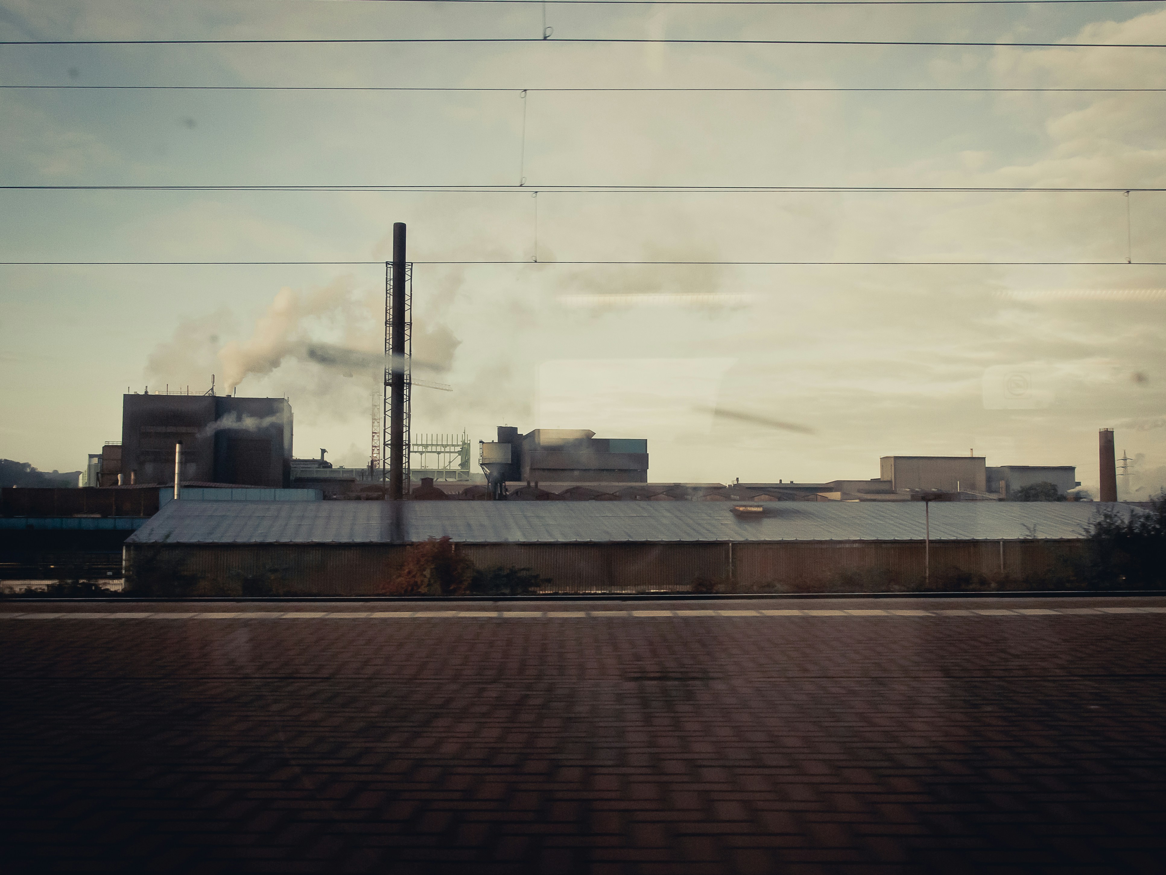 a factory with smoke coming out of it's stacks
