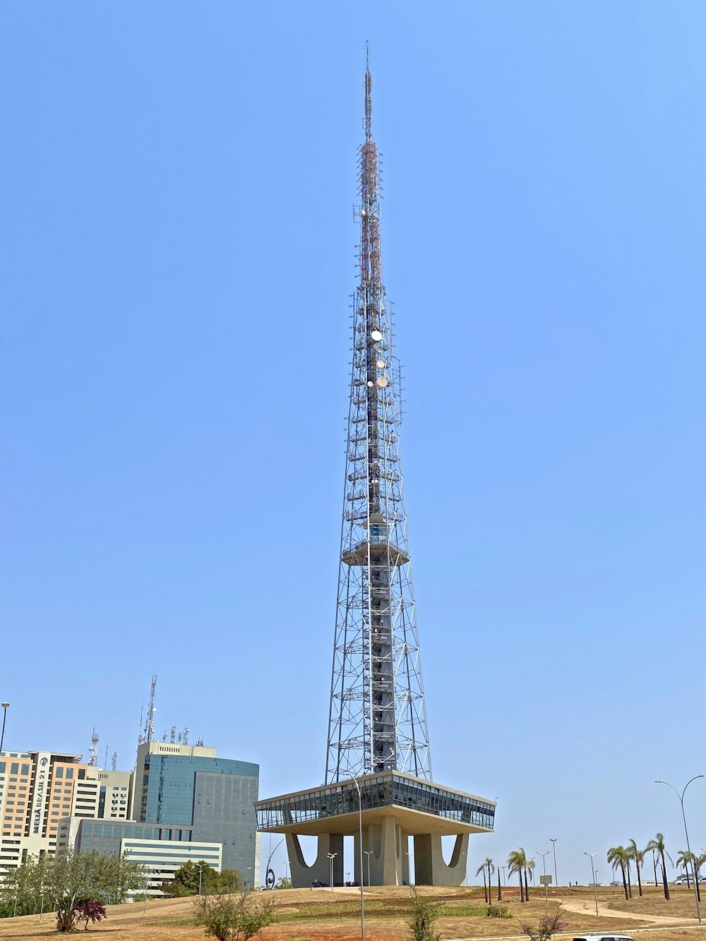 a very tall tower sitting in the middle of a field