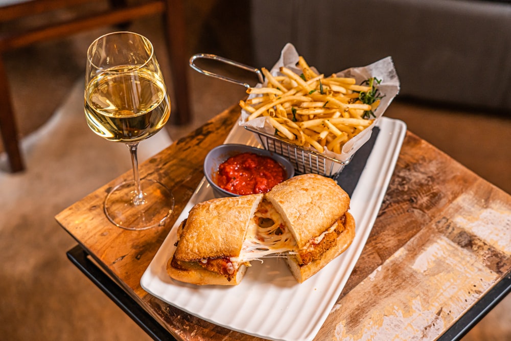 a plate of food and a glass of wine on a table