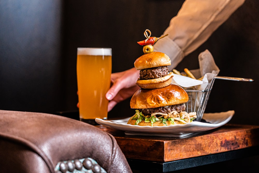 a plate of hamburgers and a glass of beer