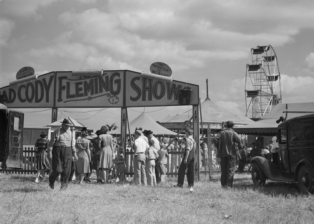 a group of people standing around a tent