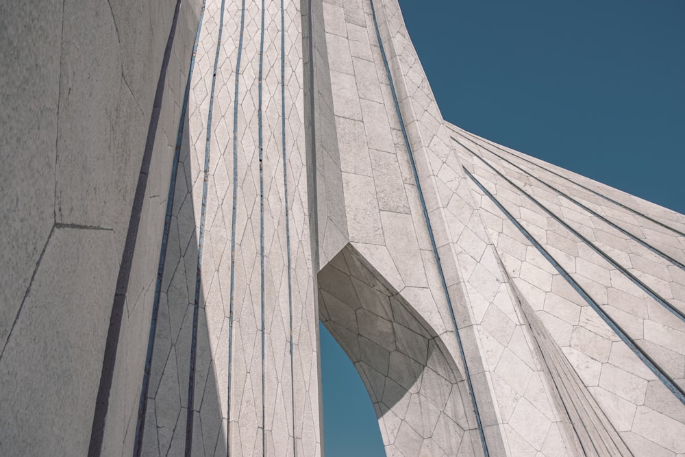 a tall white building with a sky in the background