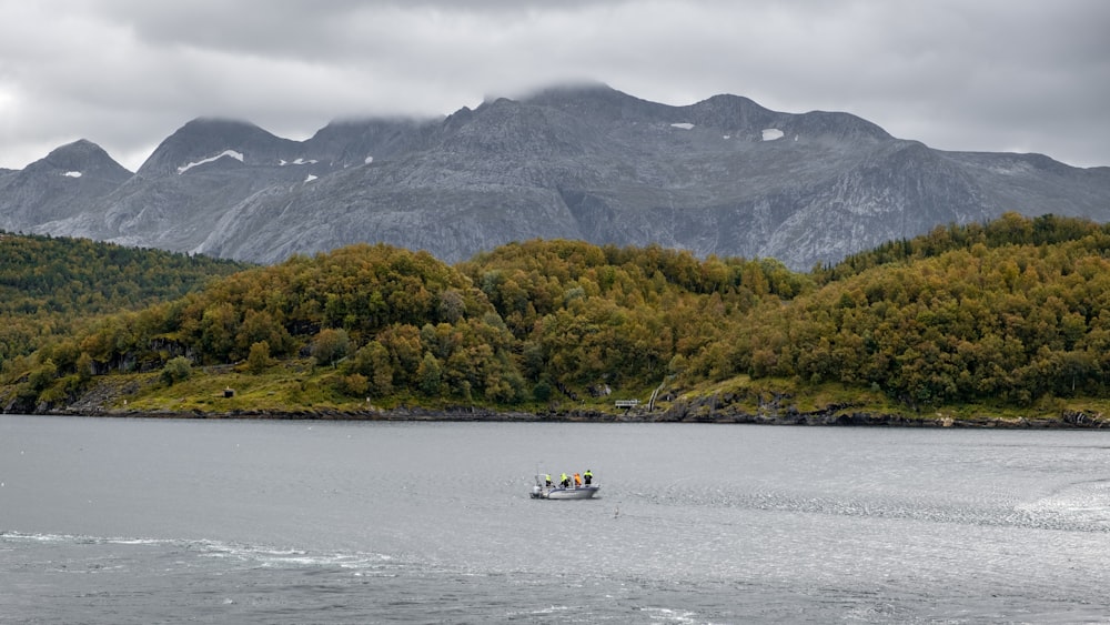 a boat in a body of water with mountains in the background