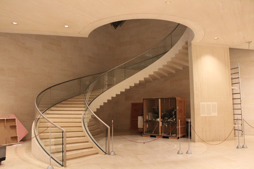 a spiral staircase inside of a building with a glass railing