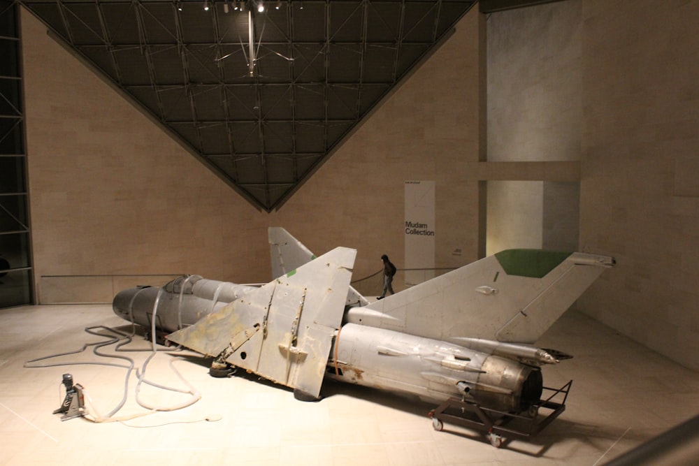 a fighter jet sitting on display in a museum