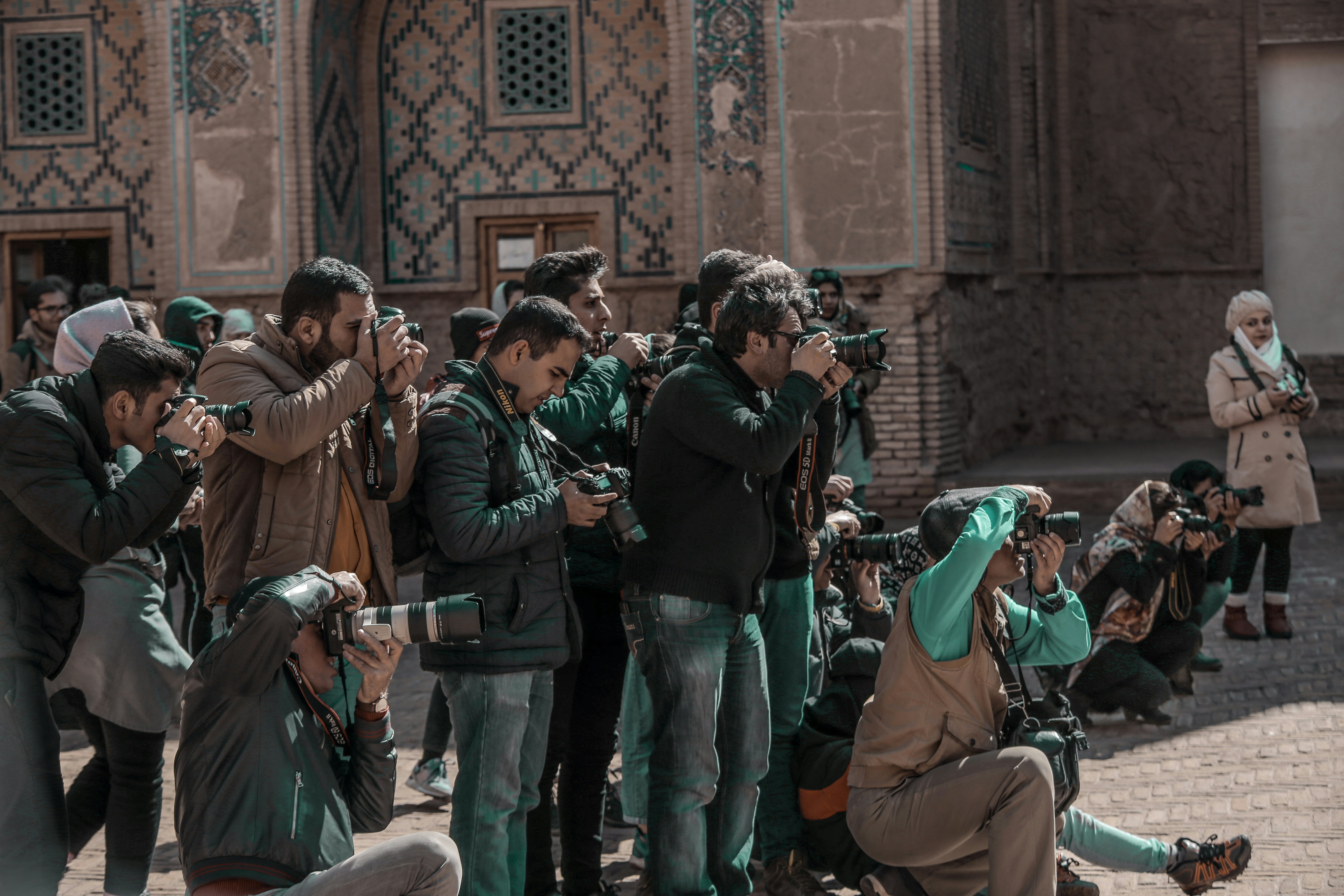 Paparazzi surrounding Lindsay Lohan, symbolizing public identity versus inner self in manifestation journey.