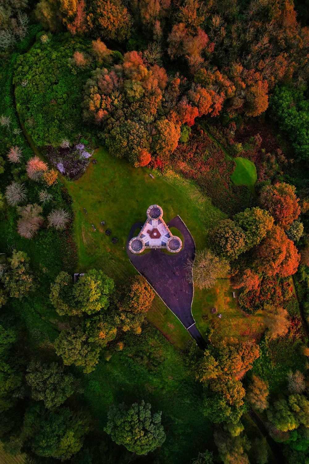 an aerial view of a house surrounded by trees