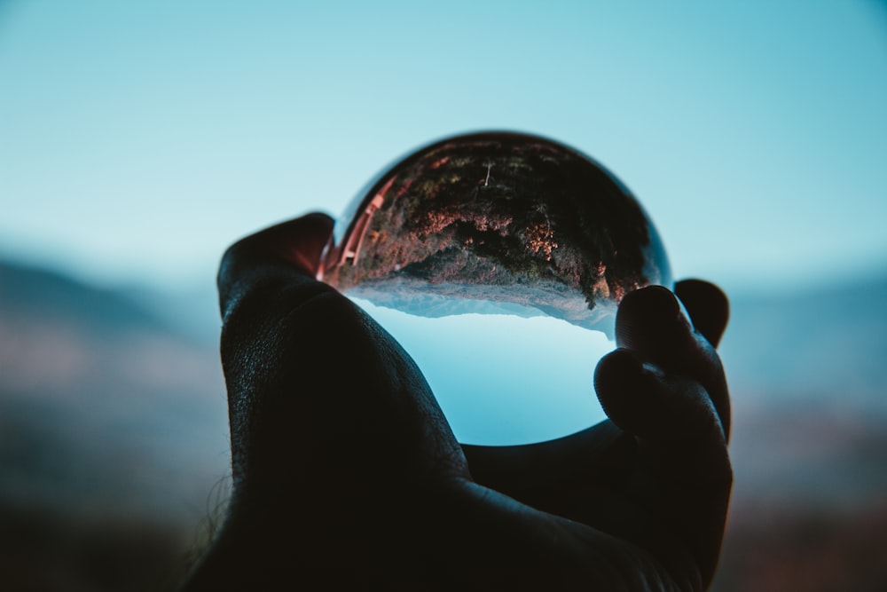 a person holding a crystal ball in their hand