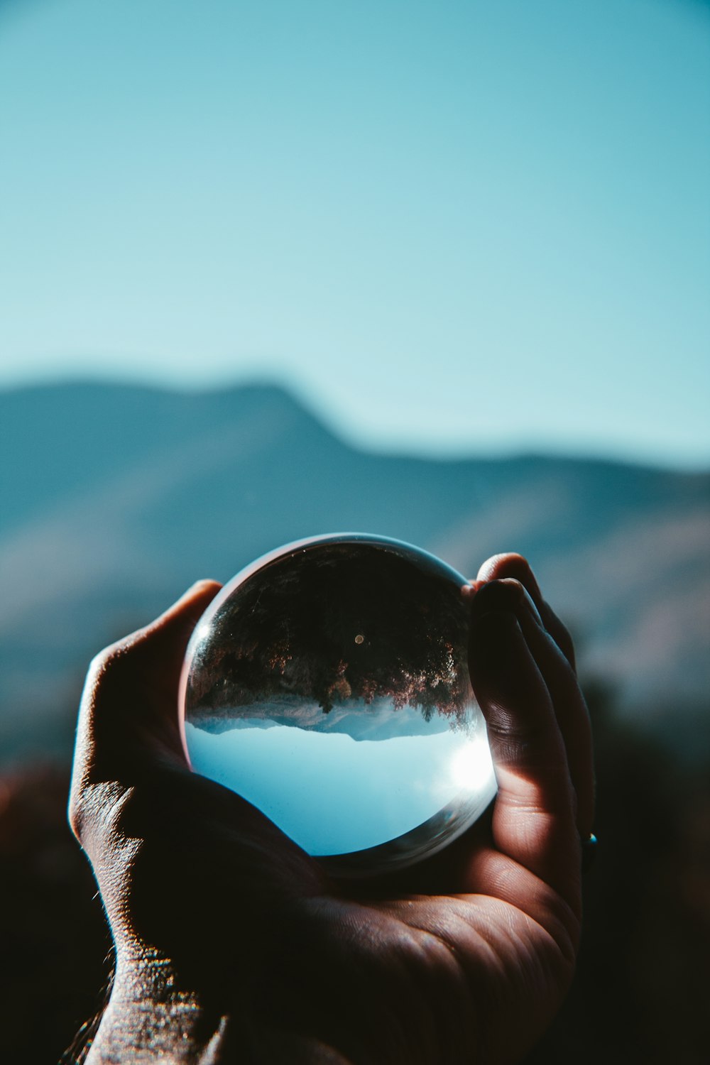 a person holding a crystal ball in their hand