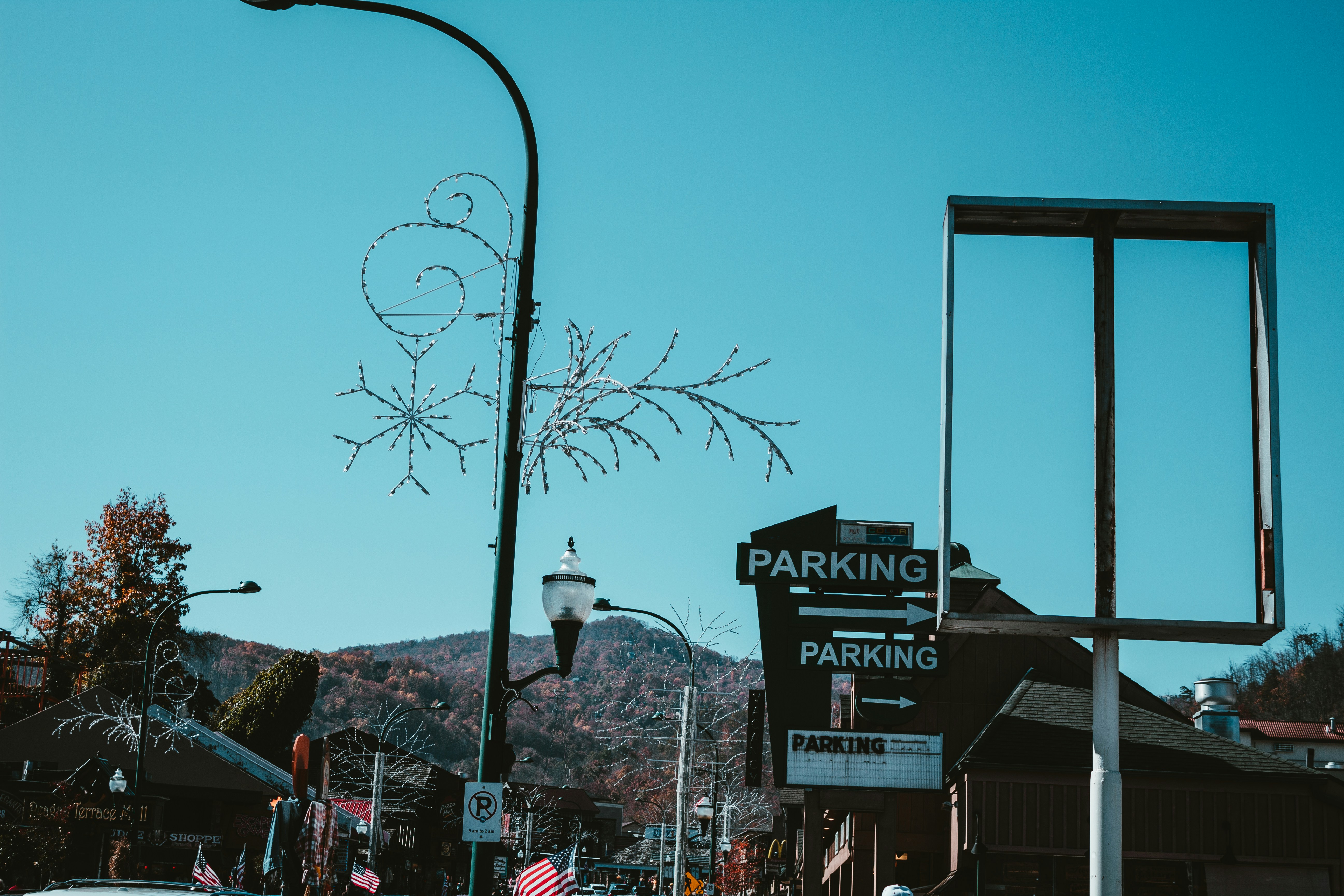 a parking sign on the side of a road