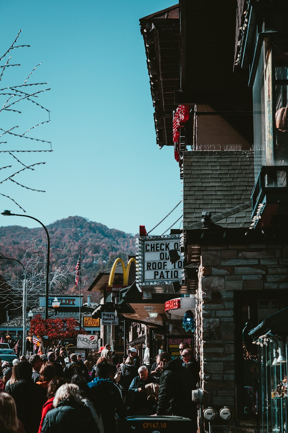 a crowd of people walking down a street next to a building