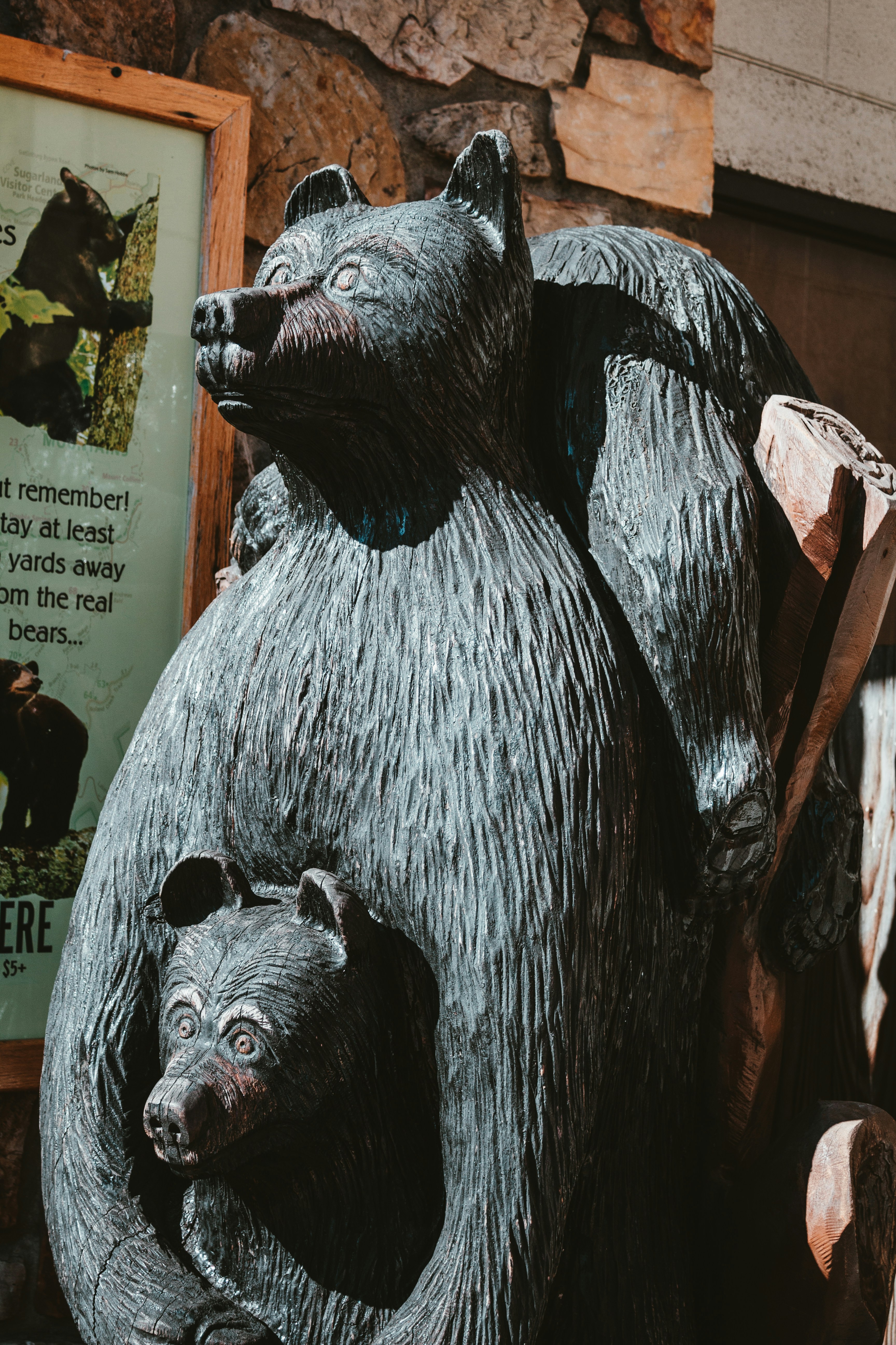 a statue of a bear holding a baby bear