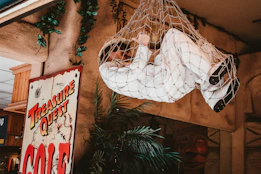 a man in a white suit hanging from a net