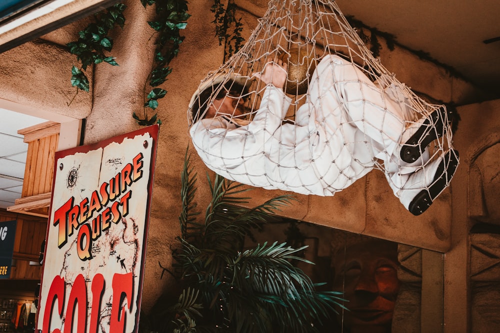 a man in a white suit hanging from a net