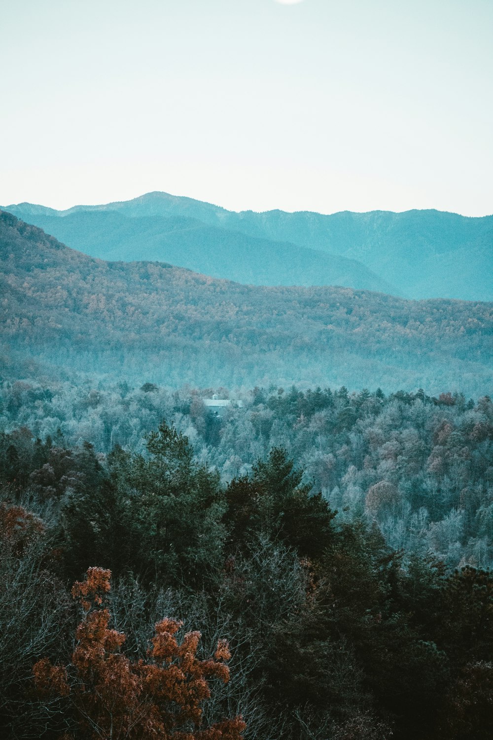 a view of a mountain range with a full moon in the distance