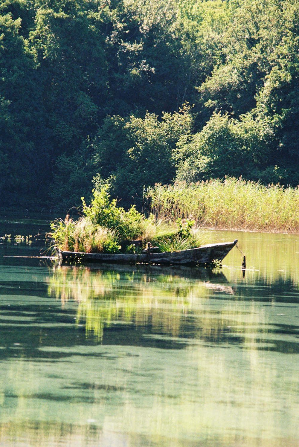 a small boat floating on top of a lake