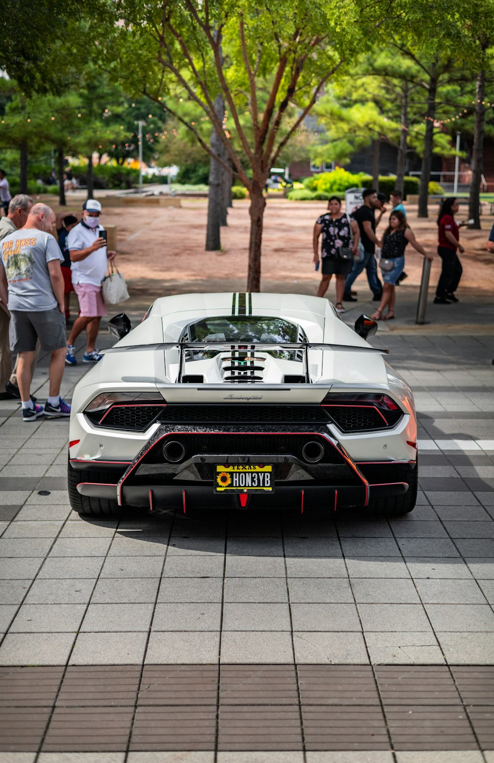 a white sports car parked on the side of the road