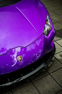 a purple sports car parked on the side of the road