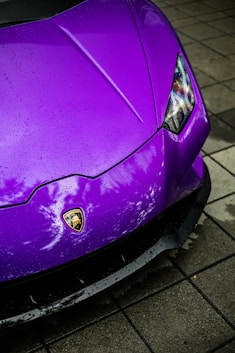 a purple sports car parked on the side of the road