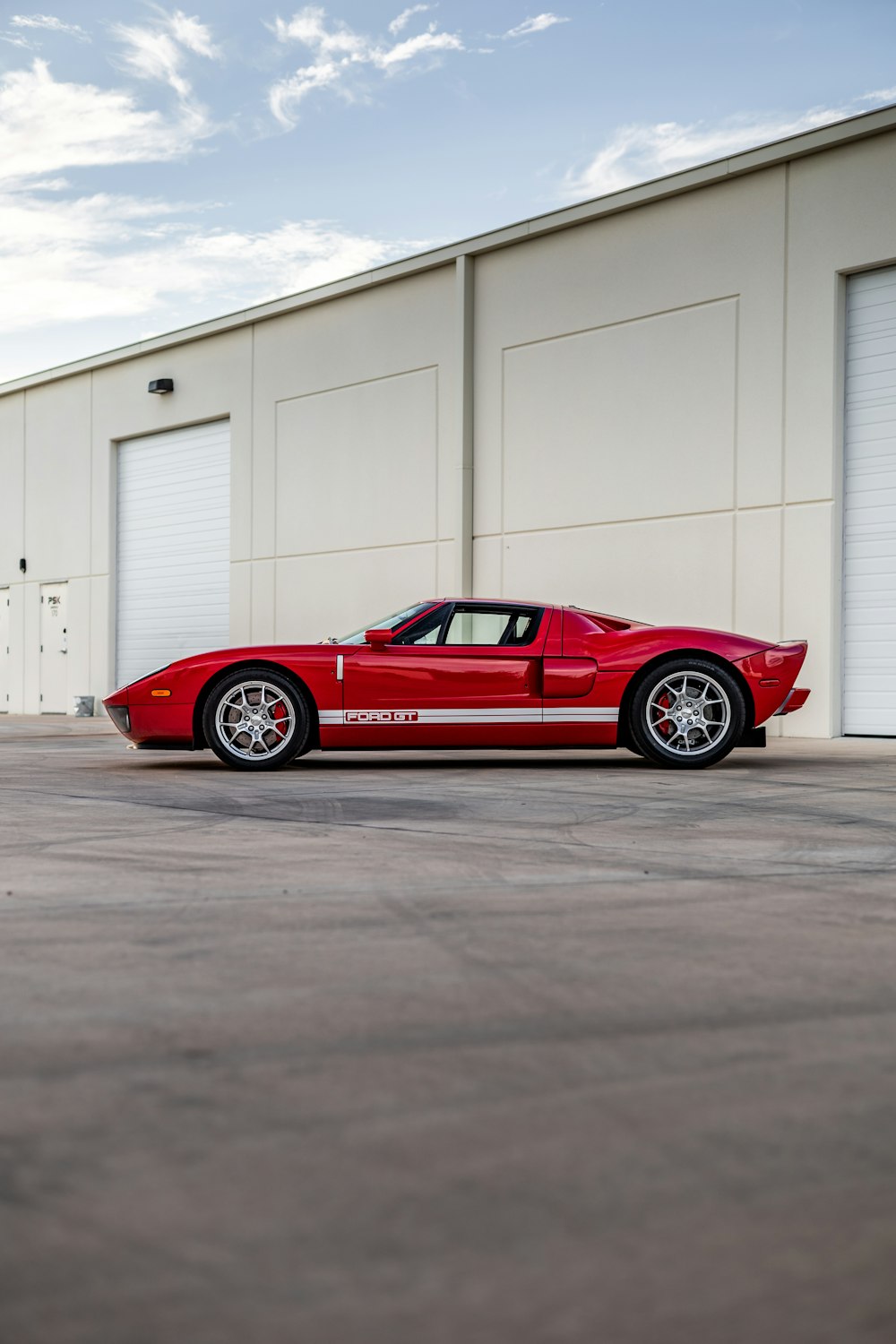 a red sports car parked in front of a building