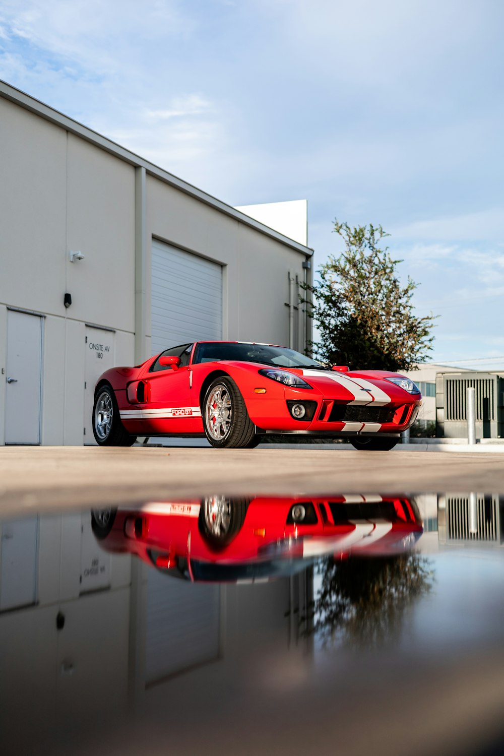 a red sports car parked in front of a building