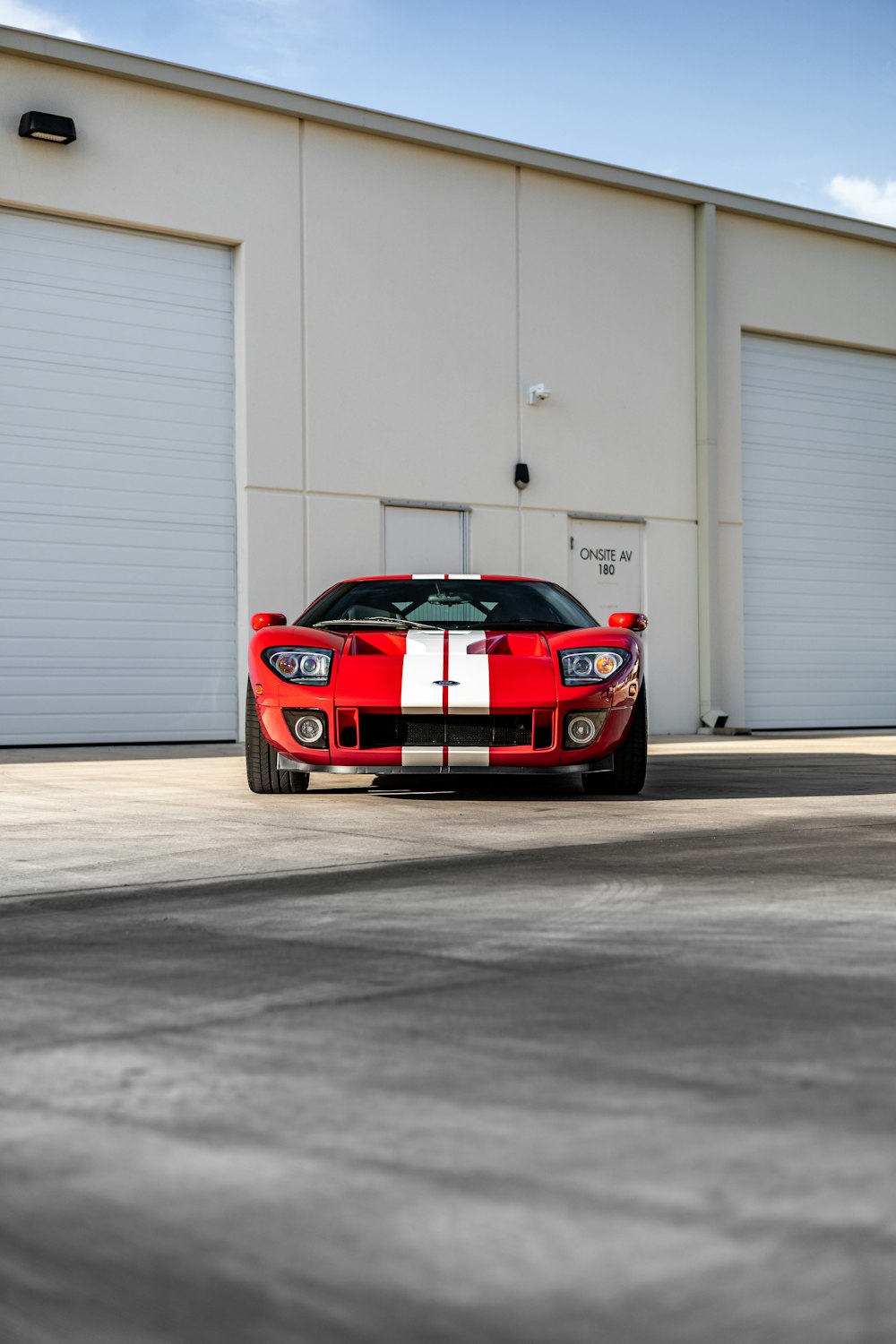 a red sports car parked in front of a garage