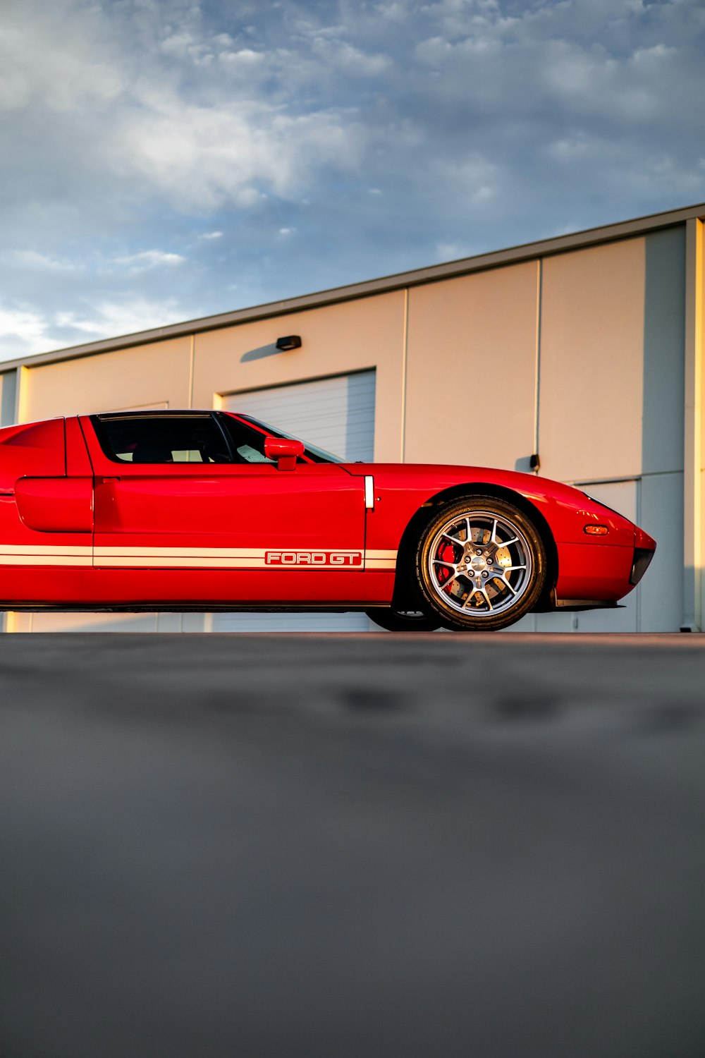 a red sports car parked in front of a building