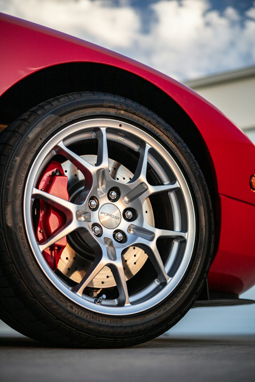 a close up of a red sports car tire