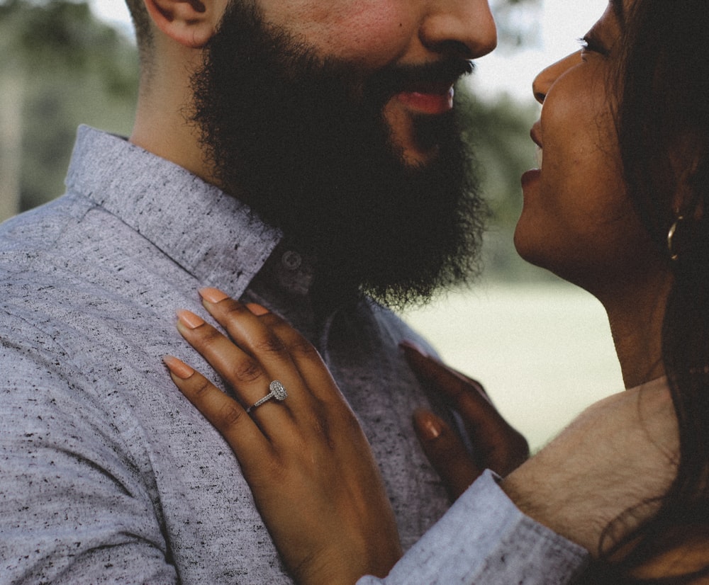 a close up of a man and a woman with a ring