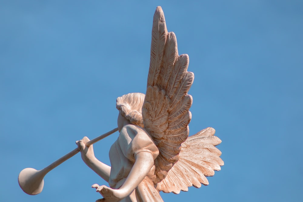 a statue of an angel holding a baseball bat