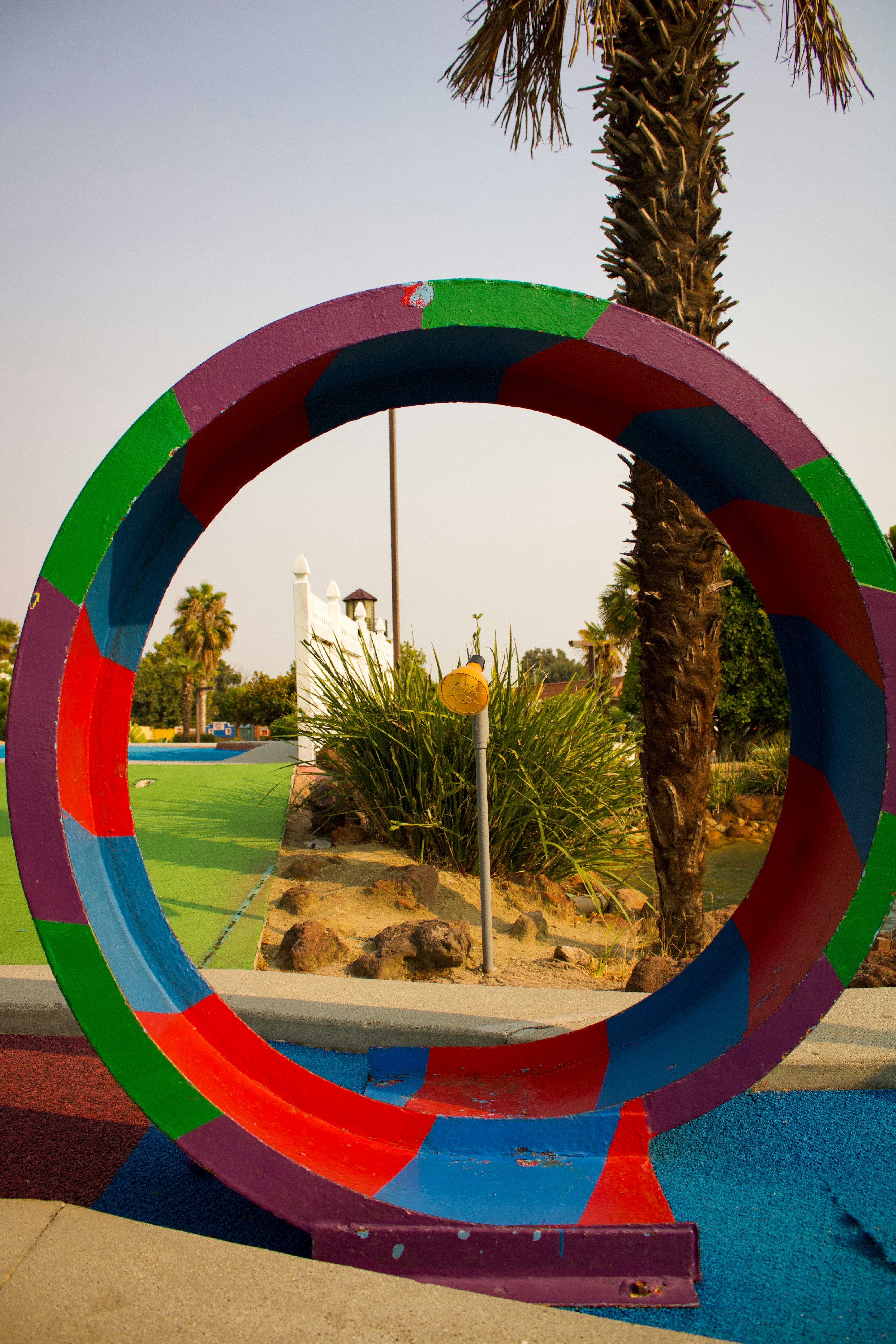 Colorful miniature golf course with a small lighthouse obstacle