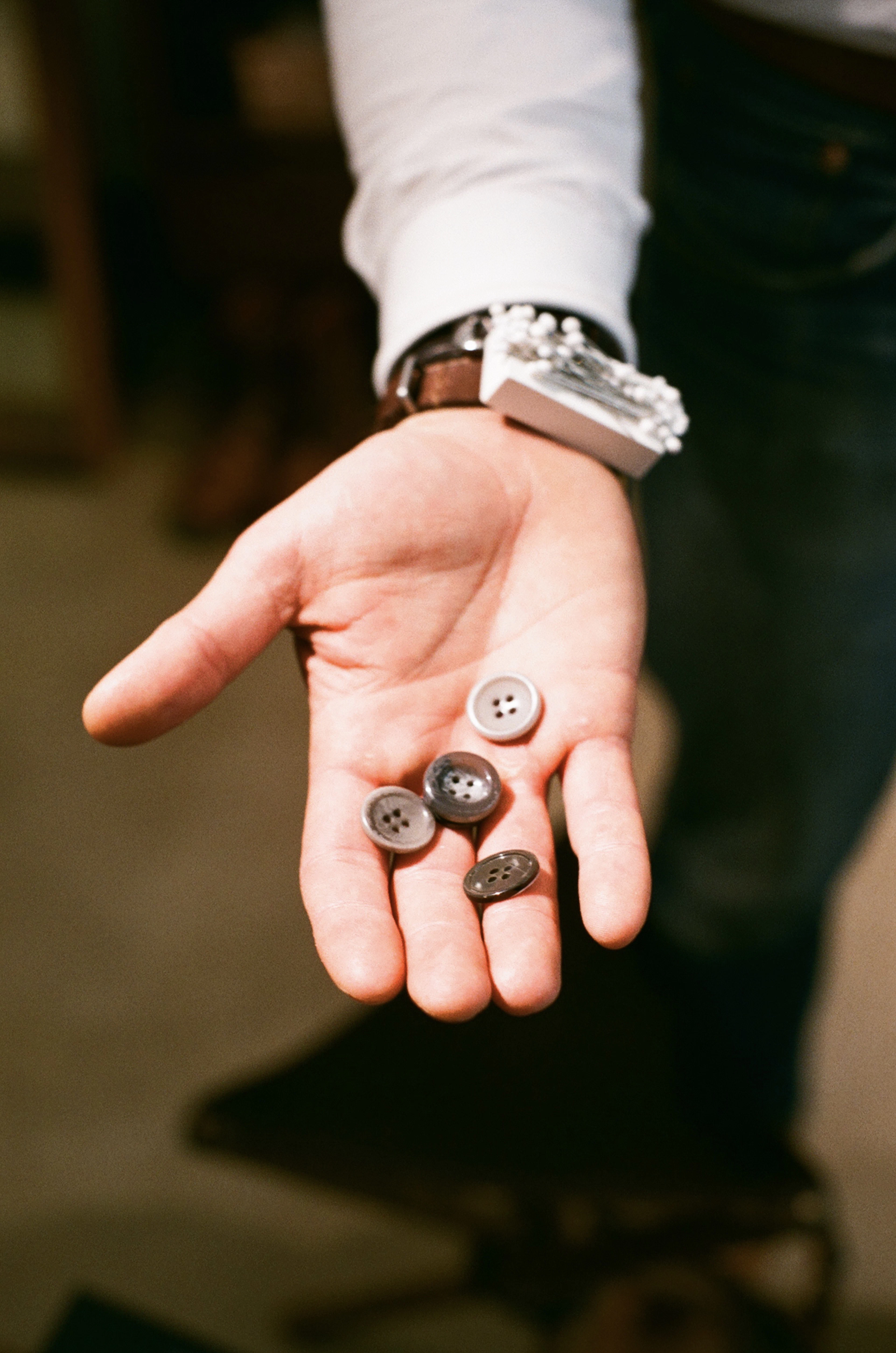 Two shirt buttons held in a palm