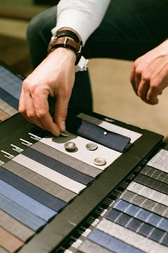 A designer reviewing print samples with various textures and colors.