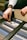Close-up of hands selecting fabric samples for furniture customization.