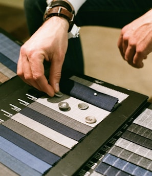 a man is working on a piece of cloth