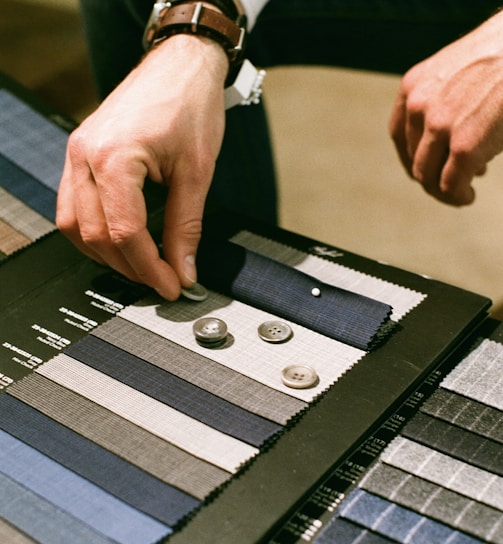 a man is working on a piece of cloth