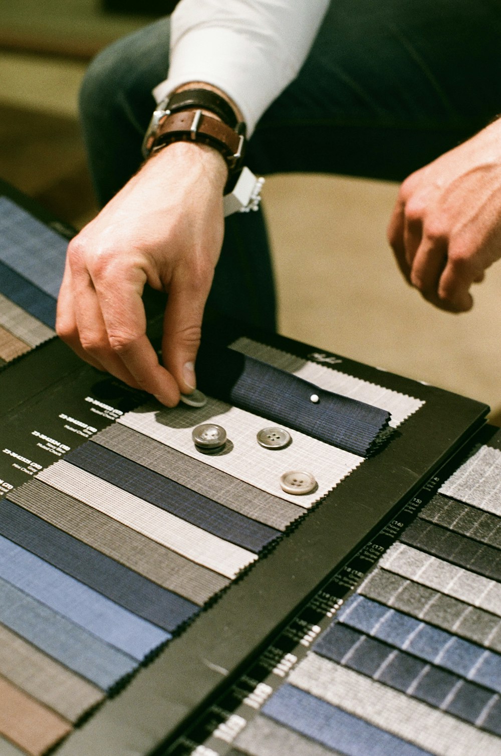 a man is working on a piece of cloth