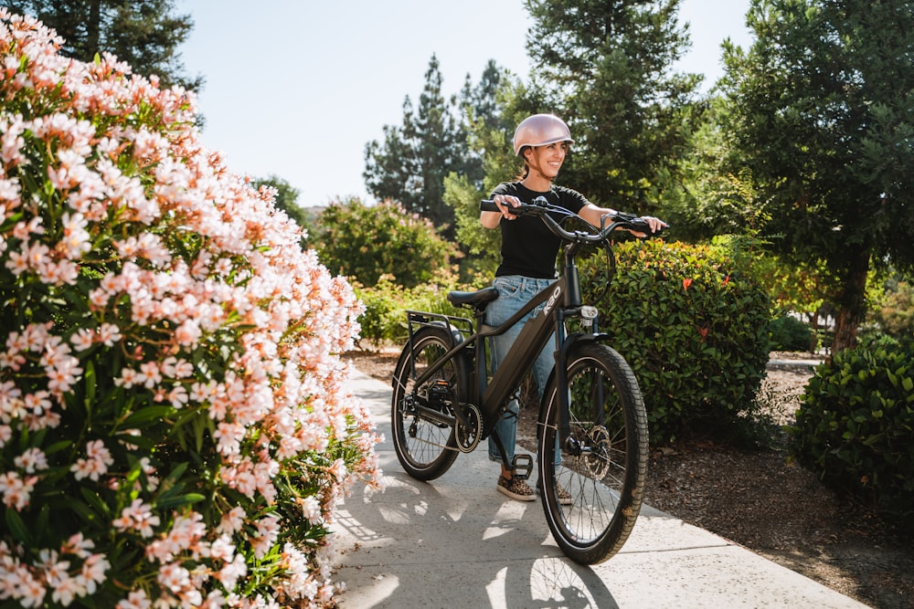 a man riding a bike down a sidewalk