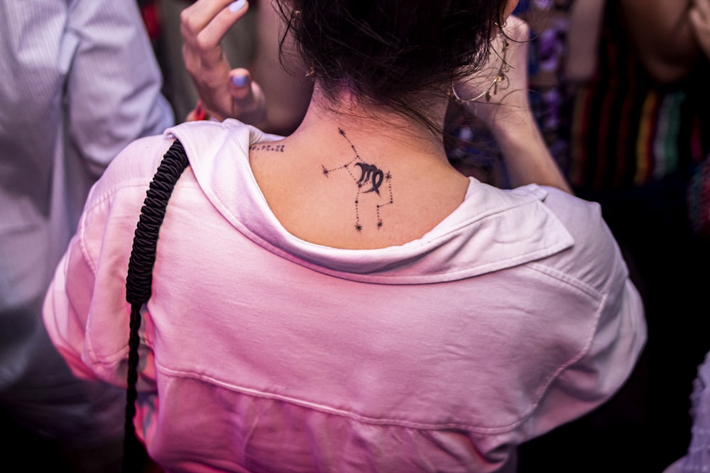 a woman with a tattoo on her back