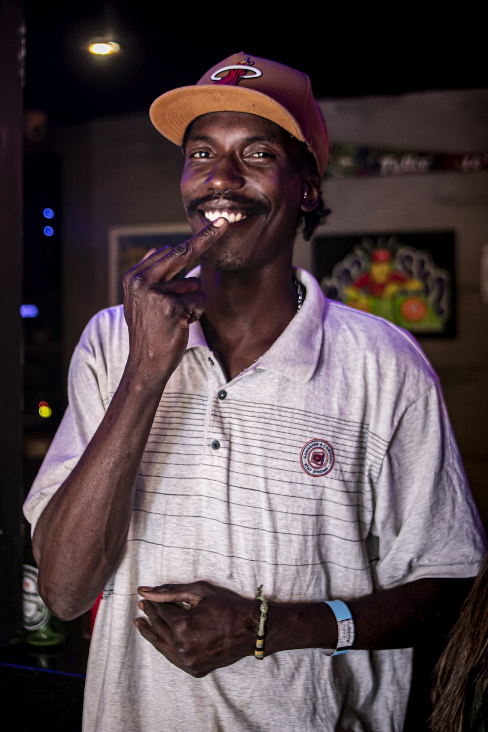 a man with a hat on and a cigar in his mouth