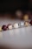 A close-up of vibrant, handcrafted beads displayed on a rustic wooden surface.