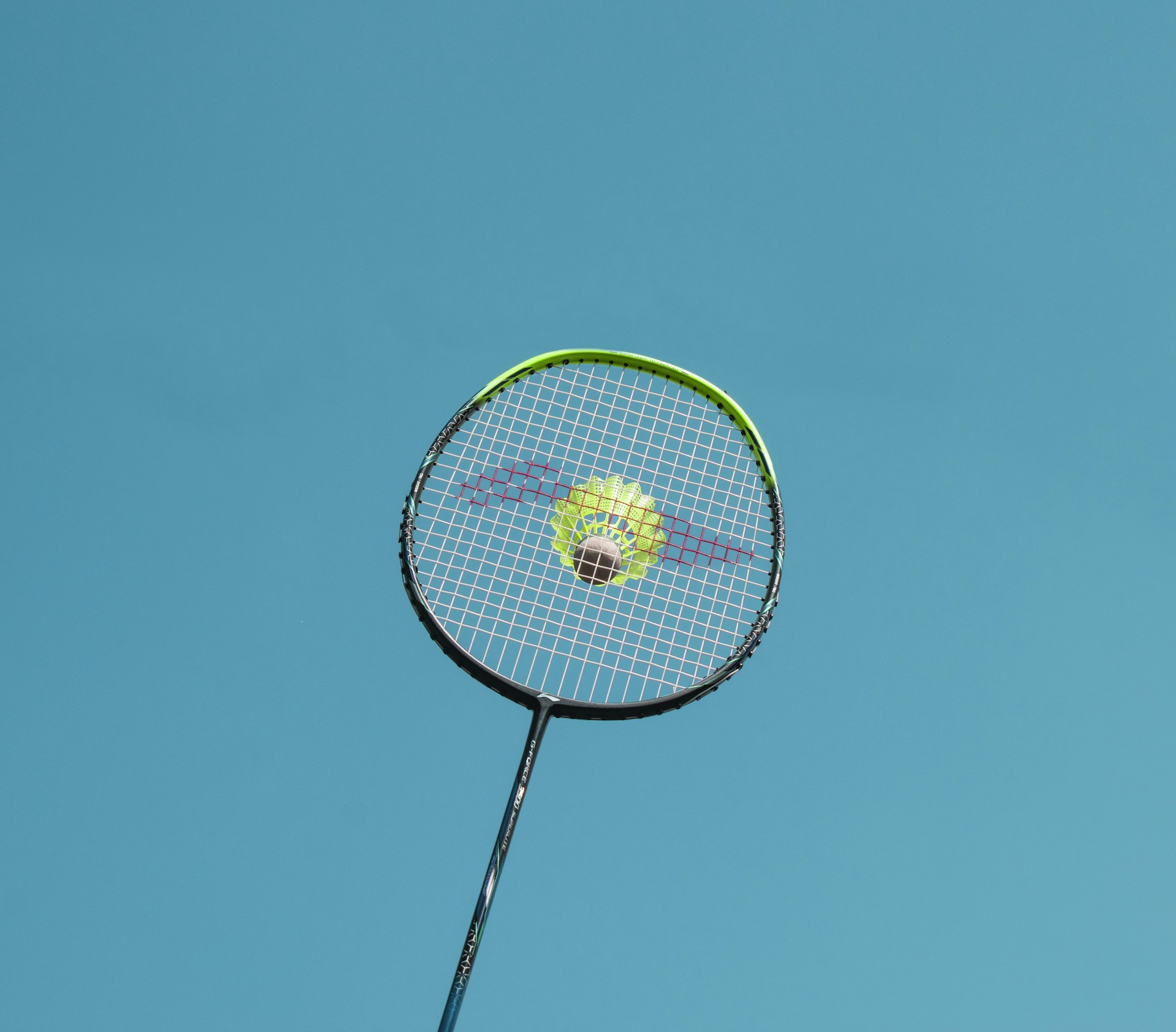 a tennis racket with a tennis ball on it