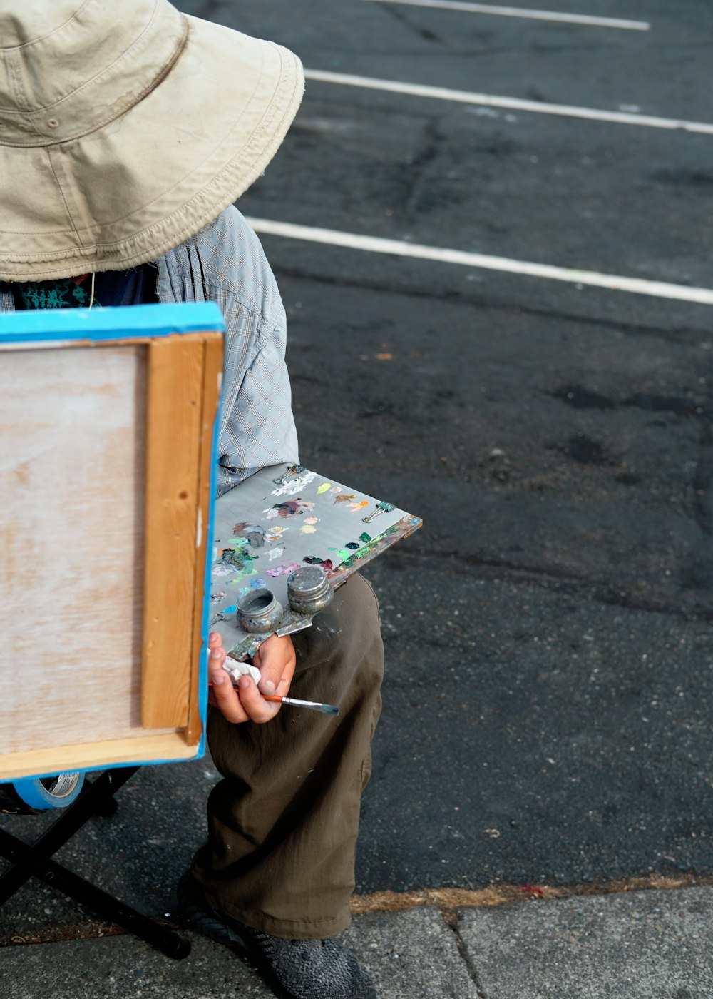 a person sitting on a chair holding a paintbrush