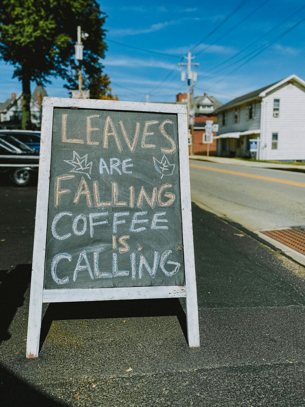 a sign that says leaves are falling coffee is calling