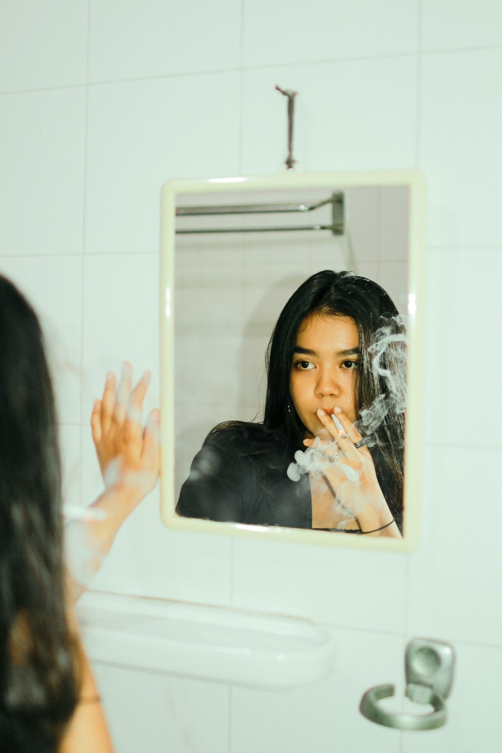 a woman brushing her teeth in front of a mirror