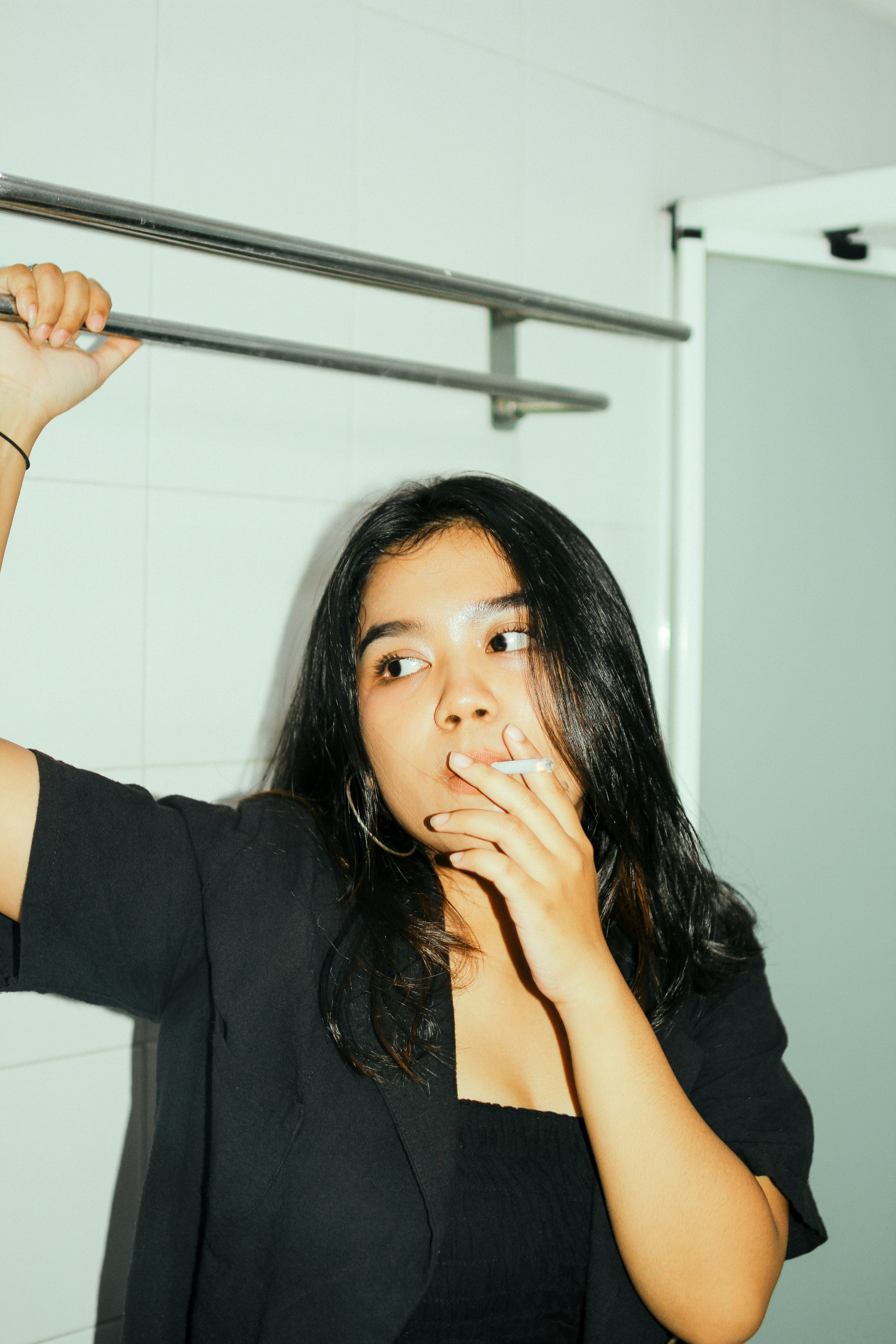 a woman brushing her teeth in a bathroom